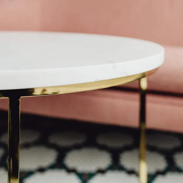 The Blink coffee table, a round white marble top on brass legs